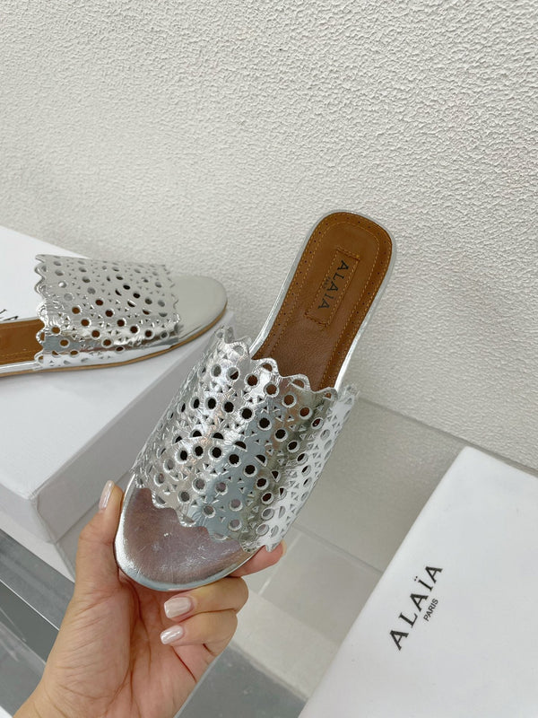 ALAIA VIENNE FLAT MULES IN SILVER LAMBSKIN
